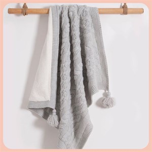 Вязанный плед NipperLand станет уютным и мягким акцентом